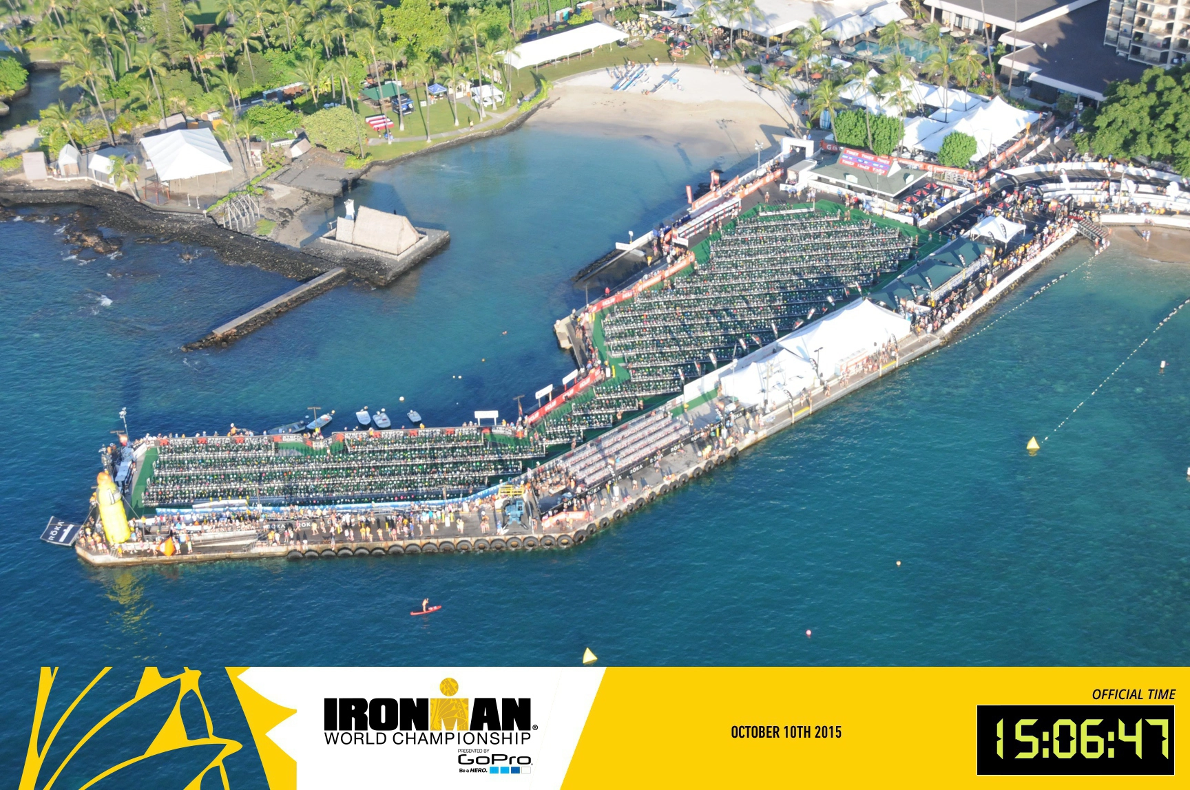 Aerial view of rows of bikes on a jetty in aqua blue water, photo branded Ironman World Champion, October 10th 2015